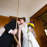 Couple kissing while ringing the church bell